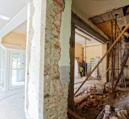 man climbing on ladder inside room